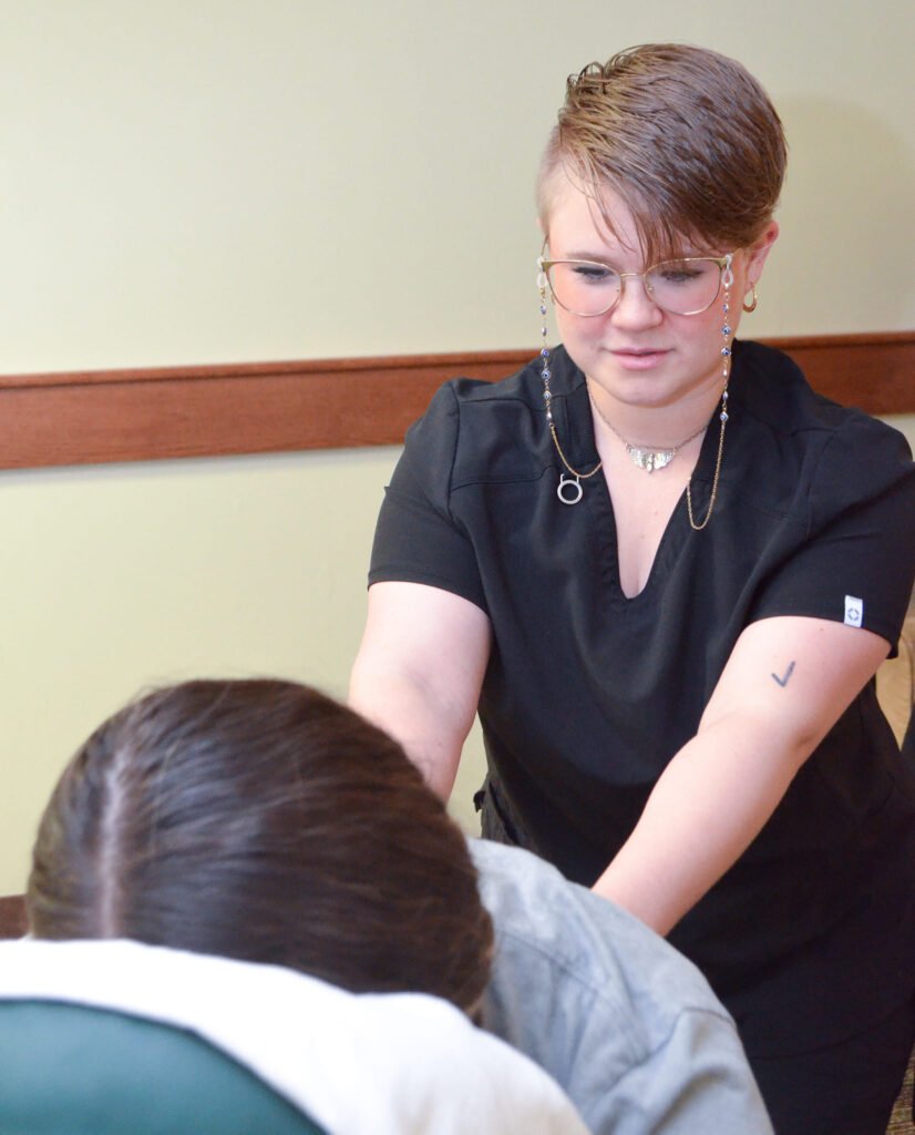 Charis Christopher giving a massage at Care Is, LLC