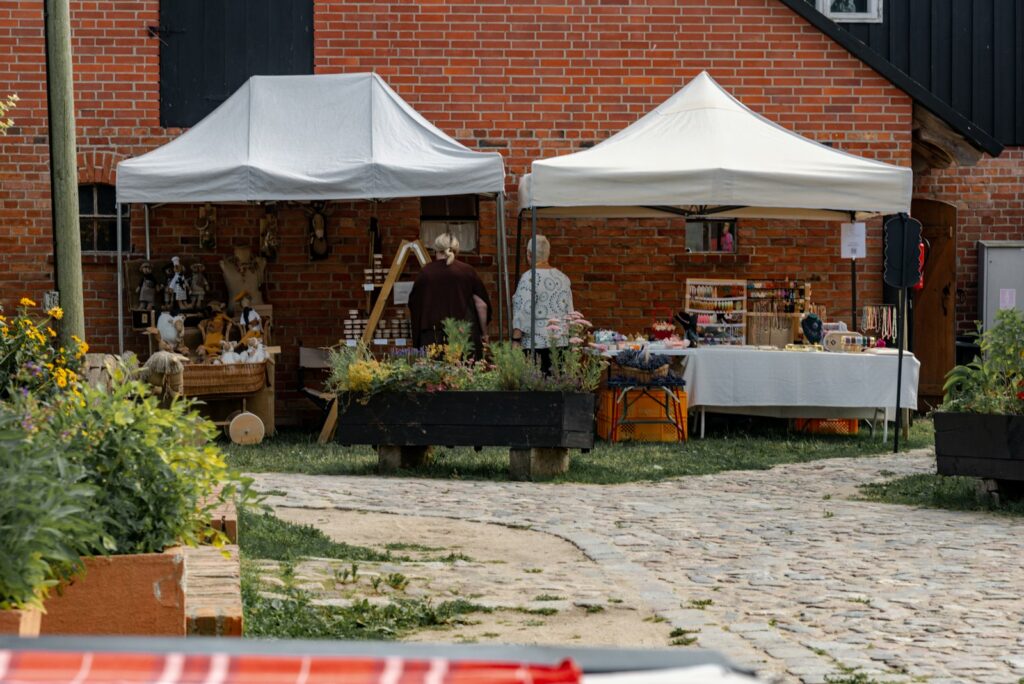 Market tents outside a brick building